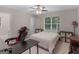 Bright bedroom with a ceiling fan, a window, and a gaming setup at 445 Royal St, Mcdonough, GA 30253