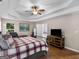 Bedroom features a ceiling fan, wood flooring, natural light, and an adjoining bathroom at 445 Royal St, Mcdonough, GA 30253