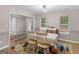 Cozy dining area with white table, wood floors, and bright natural light at 445 Royal St, Mcdonough, GA 30253