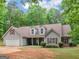 Charming single-story home features gray siding, brown roof and attached two-car garage at 445 Royal St, Mcdonough, GA 30253