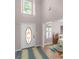 Inviting foyer features a decorative front door, high ceilings, and views into the dining area at 445 Royal St, Mcdonough, GA 30253