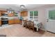 The updated kitchen has stainless steel appliances, tile flooring, and an eat-in dining area at 445 Royal St, Mcdonough, GA 30253