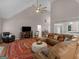 Spacious living room with vaulted ceiling, large fan, and views into the kitchen and dining area at 445 Royal St, Mcdonough, GA 30253