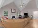 Living room with fireplace, vaulted ceilings, large sofa, and view of the windows at 445 Royal St, Mcdonough, GA 30253