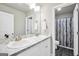 Bathroom featuring double sinks with marble countertops and a decorative shower curtain at 715 Colvin Dr, Locust Grove, GA 30248