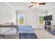 Bedroom with carpet flooring, ceiling fan, queen bed, and crib at 715 Colvin Dr, Locust Grove, GA 30248