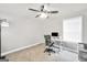 Bright bedroom with a ceiling fan, desk, and neutral carpet flooring creating a comfortable atmosphere at 715 Colvin Dr, Locust Grove, GA 30248