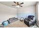 Inviting bedroom with ceiling fan, comfortable seating, and a carpet flooring, creating a versatile space at 715 Colvin Dr, Locust Grove, GA 30248