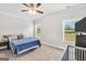 Bedroom with carpet flooring, ceiling fan, queen bed, and crib at 715 Colvin Dr, Locust Grove, GA 30248