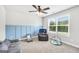 Cozy bedroom with a ceiling fan, board and batten, and carpet flooring, creating a comfortable atmosphere at 715 Colvin Dr, Locust Grove, GA 30248