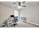 Bright bedroom with a ceiling fan, desk, and neutral carpet providing a versatile and comfortable space at 715 Colvin Dr, Locust Grove, GA 30248