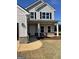 Charming covered front porch with white columns and black shutters on a two-story home at 715 Colvin Dr, Locust Grove, GA 30248