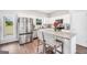 Bright kitchen with a stainless-steel refrigerator, island with bar seating, and a view to backyard at 715 Colvin Dr, Locust Grove, GA 30248
