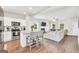 Modern kitchen with stainless steel appliances, a center island, and an open view to the living area at 715 Colvin Dr, Locust Grove, GA 30248