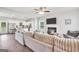 Bright living room featuring a plush sectional sofa, fireplace, and open view to the modern kitchen at 715 Colvin Dr, Locust Grove, GA 30248