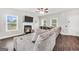 Spacious living room with fireplace, large sectional sofa, and a view of the serene backyard at 715 Colvin Dr, Locust Grove, GA 30248