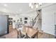 Open-concept view showing kitchen, dining area, living room with fireplace, and staircase to the upper level at 715 Colvin Dr, Locust Grove, GA 30248