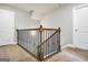 Staircase featuring carpet flooring and wood and metal handrail at 715 Colvin Dr, Locust Grove, GA 30248