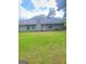 Home featuring a spacious backyard with lush green grass and privacy at 324 Cynthia Ct, Jonesboro, GA 30238