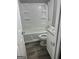 Tiled shower and bathtub combo with white cabinetry, and modern fixtures at 324 Cynthia Ct, Jonesboro, GA 30238