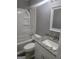 Updated bathroom features a shower-tub combo with a granite countertop vanity, offering style and functionality at 324 Cynthia Ct, Jonesboro, GA 30238