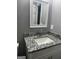 Bathroom vanity with granite countertop, sleek faucet, and white cabinetry at 324 Cynthia Ct, Jonesboro, GA 30238