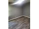 This bedroom has wood-look flooring and neutral walls, offering a simple yet comfortable space at 324 Cynthia Ct, Jonesboro, GA 30238