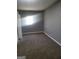 Cozy bedroom with plush carpet, a window, and neutral walls creating a comfortable atmosphere at 324 Cynthia Ct, Jonesboro, GA 30238
