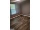 Cozy bedroom with wood-look flooring, a window, and neutral walls creating a relaxing atmosphere at 324 Cynthia Ct, Jonesboro, GA 30238
