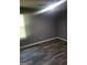 Bedroom features sleek wood-look flooring and a bright window for a comfortable living space at 324 Cynthia Ct, Jonesboro, GA 30238