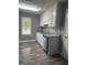 Well-lit kitchen featuring stainless steel appliances, granite countertops and modern white cabinetry at 324 Cynthia Ct, Jonesboro, GA 30238