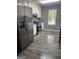 Well-lit kitchen featuring stainless steel appliances, granite countertops and modern white cabinetry at 324 Cynthia Ct, Jonesboro, GA 30238