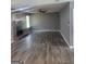 Living room with wood laminate floors, gray walls, and stone fireplace at 324 Cynthia Ct, Jonesboro, GA 30238