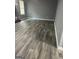 Open-concept living room with gray walls and gorgeous wood-look flooring at 324 Cynthia Ct, Jonesboro, GA 30238