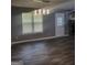 Bright living room featuring hardwood floors, a stone fireplace, and natural light at 324 Cynthia Ct, Jonesboro, GA 30238