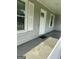 Inviting front porch features freshly painted wood paneling and traditional white trim at 324 Cynthia Ct, Jonesboro, GA 30238