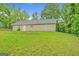 Spacious backyard featuring a well-maintained lawn, surrounded by mature trees, providing privacy and a serene environment at 126 Usher Ln, Covington, GA 30016