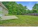 Expansive backyard with lush greenery and a concrete patio, perfect for outdoor relaxation at 126 Usher Ln, Covington, GA 30016