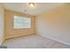 Cozy bedroom with plush carpeting and natural light streaming through a window at 126 Usher Ln, Covington, GA 30016
