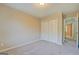 Bedroom featuring plush carpet, neutral paint, and a double-door closet at 126 Usher Ln, Covington, GA 30016