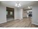 Open dining area showcasing wood-look floors, a modern light fixture, and transitions to other rooms at 126 Usher Ln, Covington, GA 30016