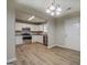 Well-lit kitchen featuring white cabinets, stainless steel appliances, and wood-look flooring at 126 Usher Ln, Covington, GA 30016