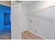 Compact laundry area with hookups and storage shelf, easy access at 126 Usher Ln, Covington, GA 30016