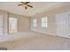 Large main bedroom with tray ceiling, plush carpeting, two windows, and ensuite access at 126 Usher Ln, Covington, GA 30016