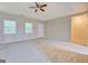 Spacious main bedroom with neutral walls and carpet, recessed ceiling, and natural light at 126 Usher Ln, Covington, GA 30016