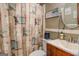 Cozy bathroom with decorative shower curtain, sink, and patterned wallpaper at 3449 Archwood Dr, Doraville, GA 30340