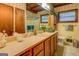 Bathroom features wood paneled cabinets, large countertop, and a glass door shower at 3449 Archwood Dr, Doraville, GA 30340
