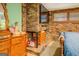 Bedroom with exposed brick fireplace, television, and dresser at 3449 Archwood Dr, Doraville, GA 30340