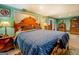 Bedroom features a large bed with blue quilt and colorful wood headboard at 3449 Archwood Dr, Doraville, GA 30340