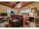 Bedroom with wood-paneled ceiling, wooden bedframe and furniture, and two windows at 3449 Archwood Dr, Doraville, GA 30340